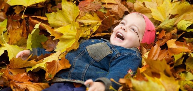 Laughing and playing in the leaves